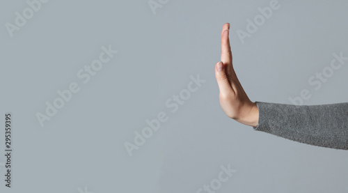 Woman showing a refuse hand gesture sign.