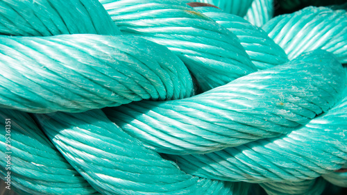 Abstract background with rope of mint color close-up. Nautical background texture. Turquoise colored cord. Wide screen background. photo