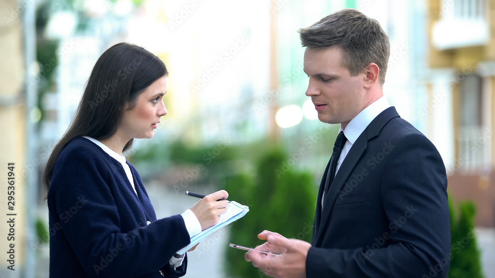 Female secretary recording in notebook male boss orders, personal assistant Female secretary recording in notebook male boss orders, personal assistant