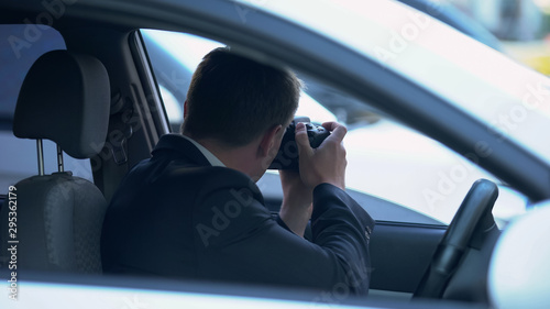 Bild auf Leinwand Yellow press journalist taking photos from car, searching for shocked news