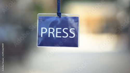 Press identification card against blurred background, privilege pass for media