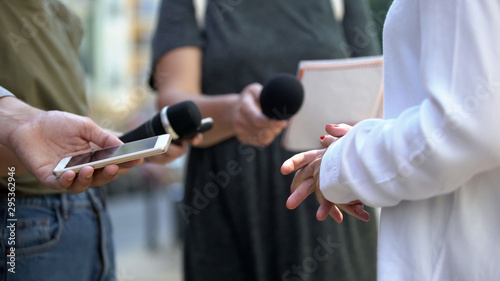 Woman gesticulating during interview with media, press conference, close-up photo
