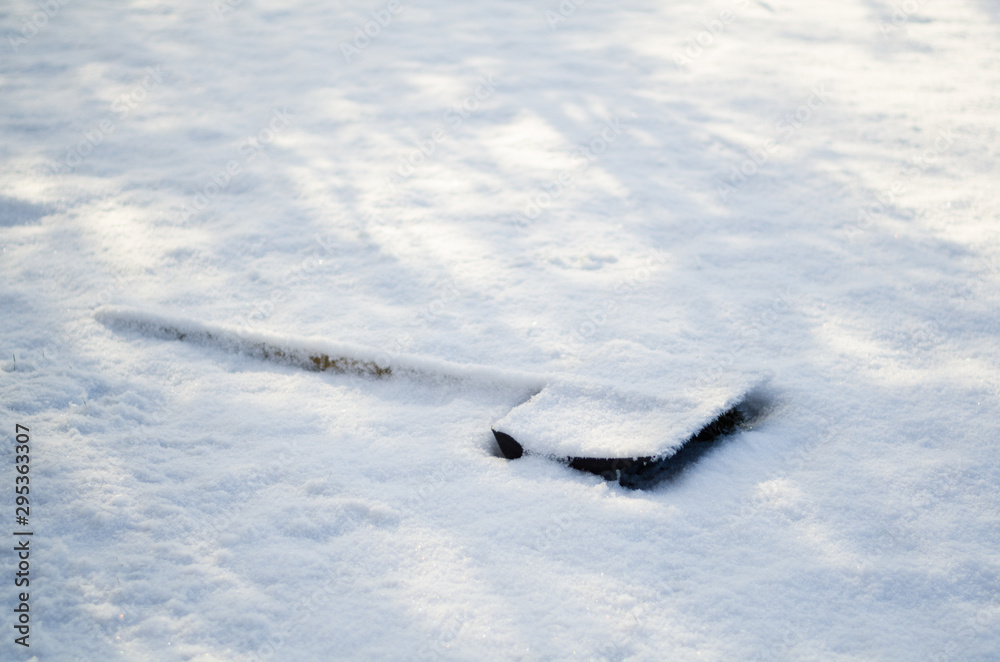 wooden snow shovel covered with snow wooden snow shovel covered with snow
