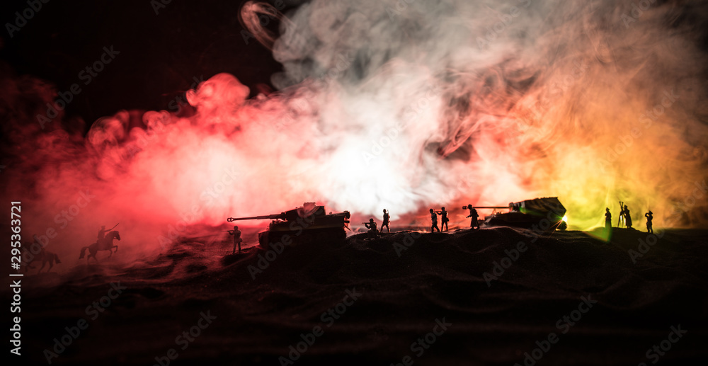 War Concept. Military silhouettes fighting scene on war fog sky background, World War German Tanks Silhouettes Below Cloudy Skyline At night. Attack scene. Armored vehicles and infantry.