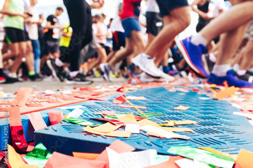 Marathon start line with confetti strewn on it