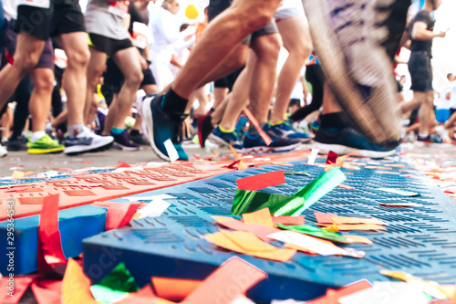 Marathon start line with confetti strewn on it