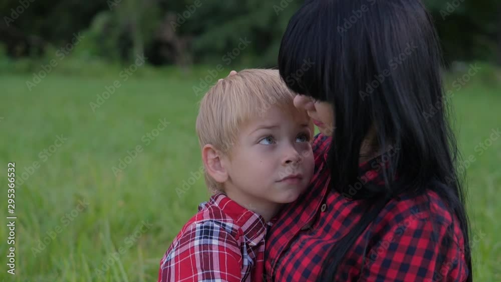 happy family mom and son concept . mom tender childhood video . slow motion video . mom a brunette girl gently hugs takes care of the lifestyle boy son blonde outdoors happy family mom and son concept . mom tender childhood video . slow motion video . mom a brunette girl gently hugs takes care of the lifestyle boy son blonde outdoors
