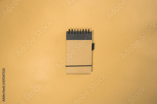 Brown notebook in orange background