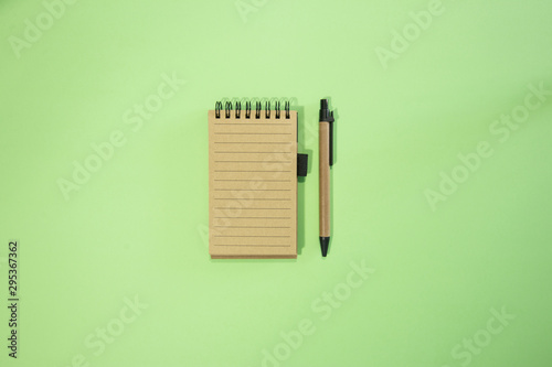 Brown notebook in green background