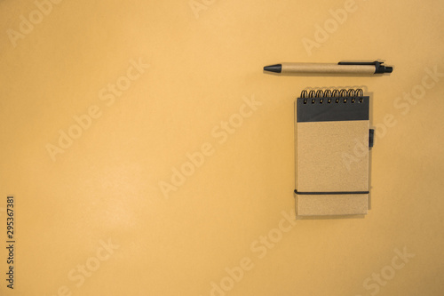 Brown notebook in orange background