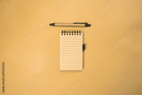 Brown notebook in orange background