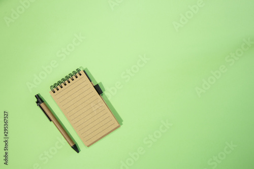 Brown notebook in green background