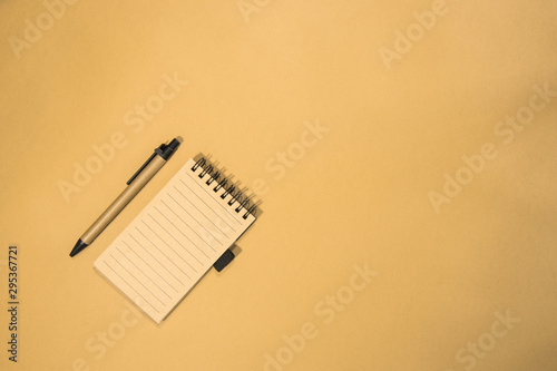 Brown notebook in orange background