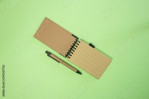 Brown notebook in green background