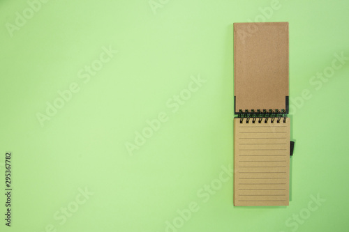 Brown notebook in green background