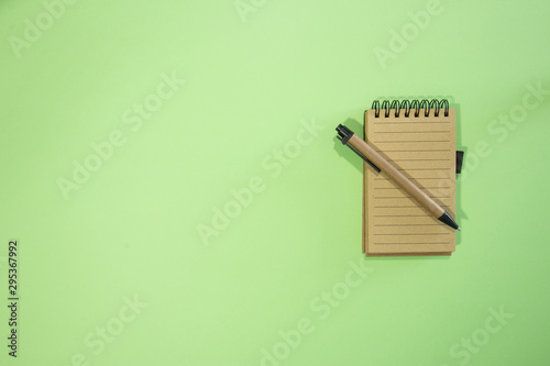 Brown notebook in green background