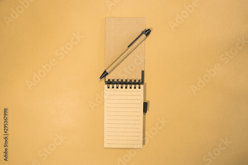 Brown notebook in orange background