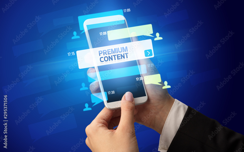Female hand typing on smartphone with PREMIUM CONTENT inscription, social networking concept Female hand typing on smartphone with PREMIUM CONTENT inscription, social networking concept