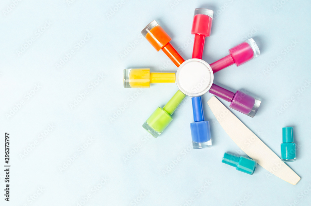colored bubbles with varnish on an isolated surface with a nail file in the shape of a flower colored bubbles with varnish on an isolated surface with a nail file in the shape of a flower