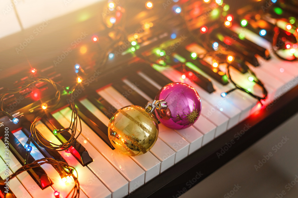 Fototapeta Piano keyboard with Christmas decoration, closeup