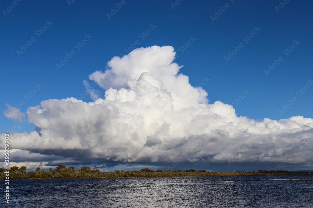 Cumulonimbus cloud over  river