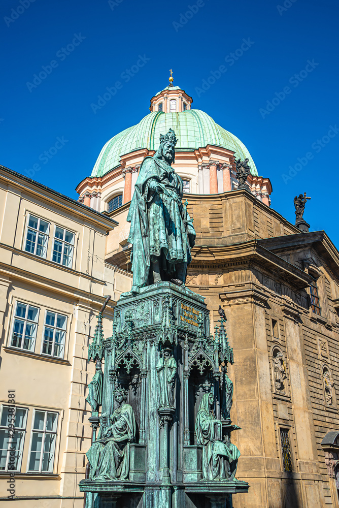 Statue of King Charles IV at Charles Bridge Tower and Saint Francis Of Assissi Church in Prague, Czech Republic