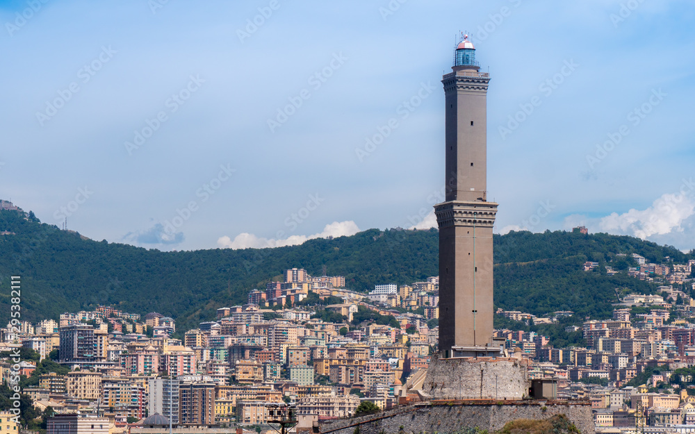 GENOA - August 14 2019: The lighthouse of Genoa (La Laterna), with city in a background.
