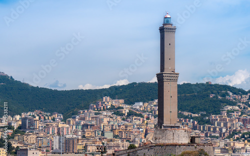 GENOA - August 14 2019: The lighthouse of Genoa (La Laterna), with city in a background. photo