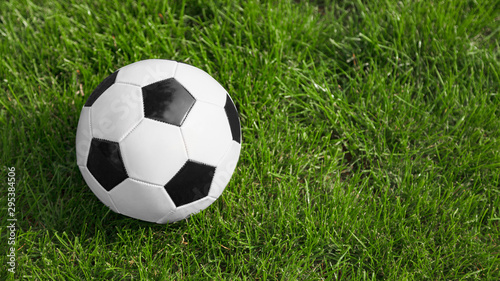 Soccer or football ball on soccer field. Space for text on the image right side