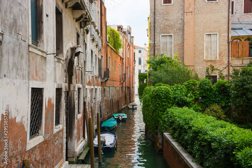View of the city narrow street and canal in Venice on a sunny day