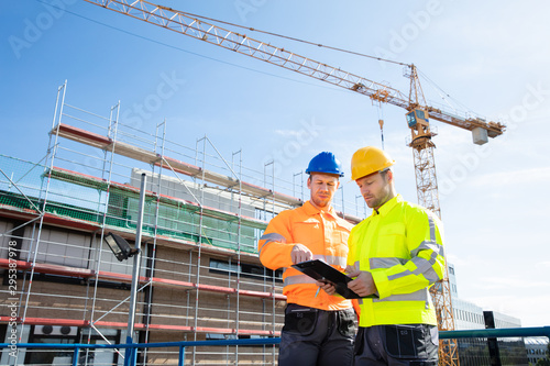 Two Male Engineers Supervising The Construction Site
