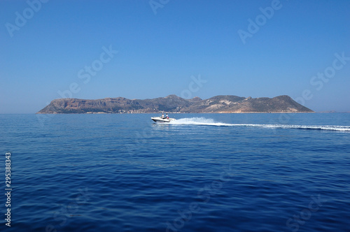 A boat in front of Kastellorizo island (Greece) as seen from Kaş (Turkey)