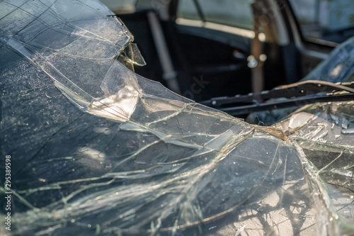 Broken car windshield, shards, pieces of broken car glass