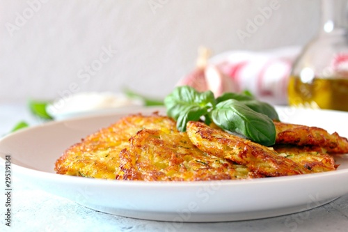 Fried potato pancakes on light background. Top view with copy space.