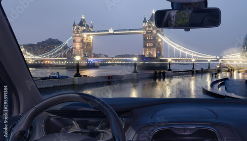 Car windshield view of Tower Bridge at night, London, UK