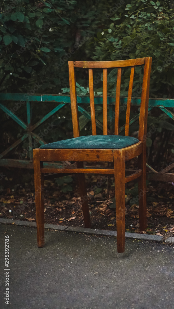 Old chair in the rural yard. Asphalt stone floor. Old chair in the rural yard. Asphalt stone floor.