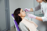 A woman is preparing for a dental examination. Woman having teeth examined at dentists. 