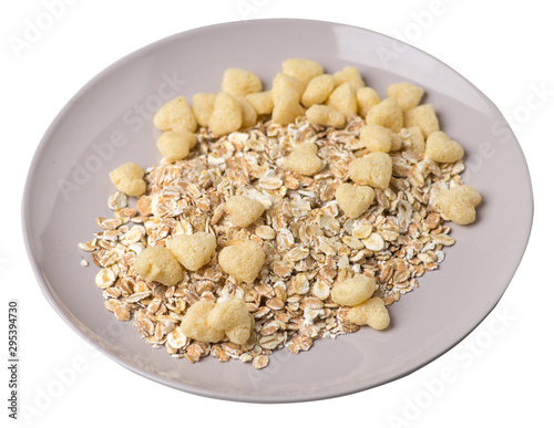 healthy breakfast on a plate isolated on white background.muesli with cornflakes, raisins, dates, pears and pineapple dried cashew nuts.breakfast top view photo