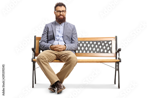 Fototapeta Bearded man sitting on a bench and smiling