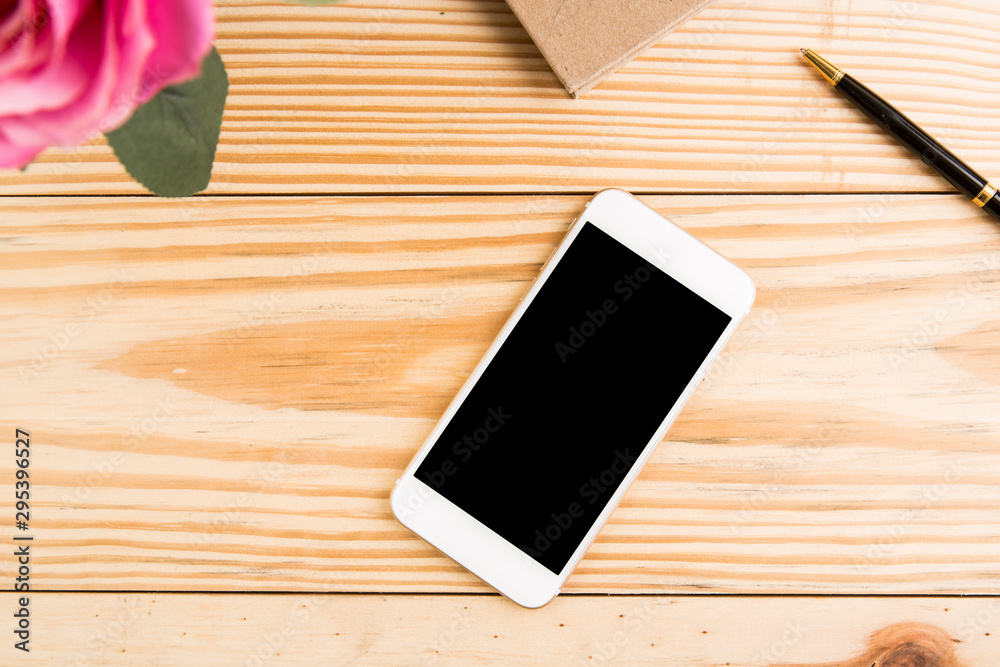 Blank smartphone on grunge wooden office table Blank smartphone on grunge wooden office table