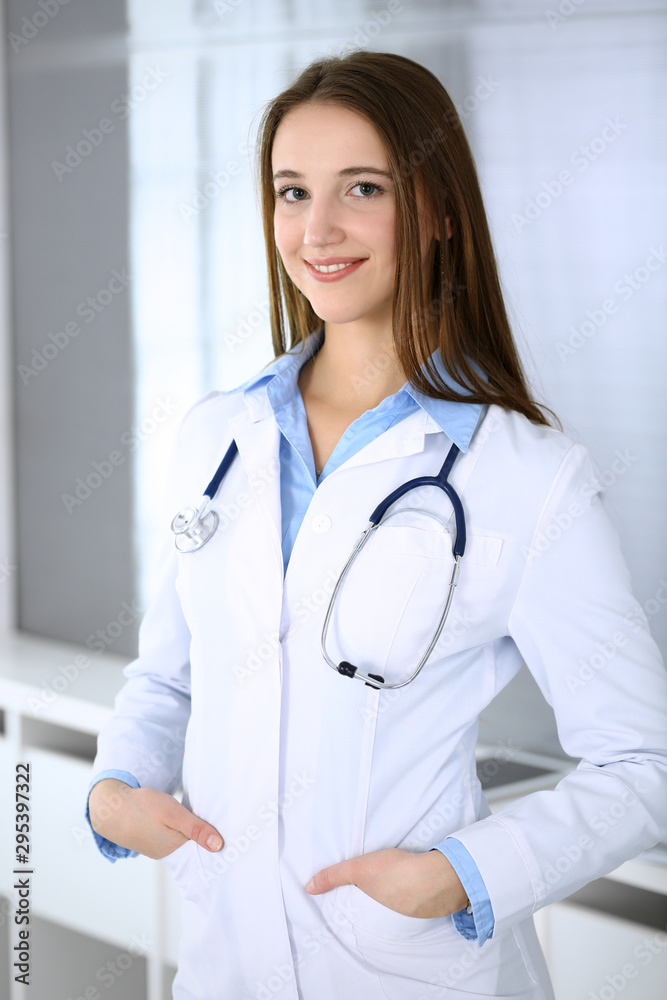 Doctor woman happy and cheerful while standing in hospital office at highlight background. Medicine and healthcare concept Doctor woman happy and cheerful while standing in hospital office at highlight background. Medicine and healthcare concept