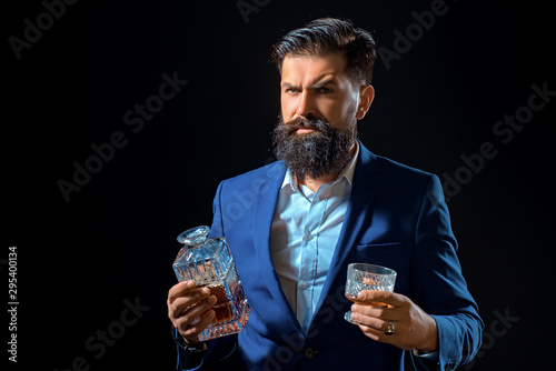 Drinking man. Alcohol abuse: drunk man looking at a glass of whiskey. Retro vintage man with whiskey or scotch. Alcoholic concept. photo