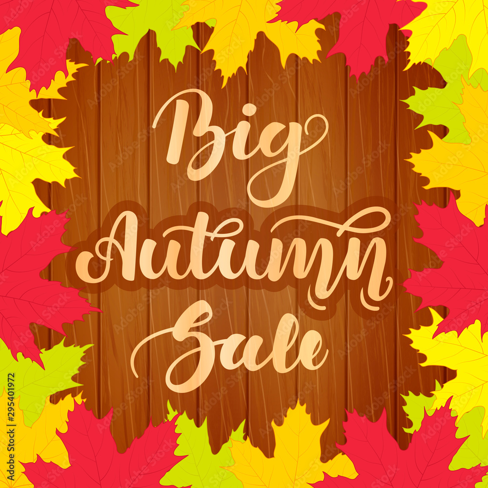 Big autumn sale. Lettering on wooden background with colorful maple leaves. Beautiful poster for sales, promotions.