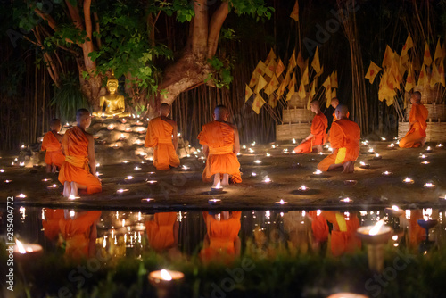 CHIANG MAI, THAILAND - May 18: Visakha Puja Day Thai monks sitting meditate with many candle at Phan Tao temple on May 18, 2019 in Chiang Mai, Thailand.
