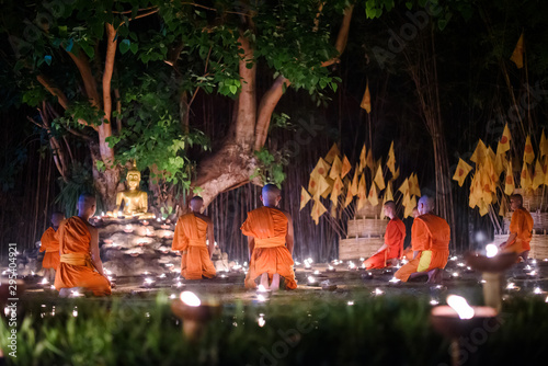 CHIANG MAI, THAILAND - May 18: Visakha Puja Day Thai monks sitting meditate with many candle at Phan Tao temple on May 18, 2019 in Chiang Mai, Thailand.