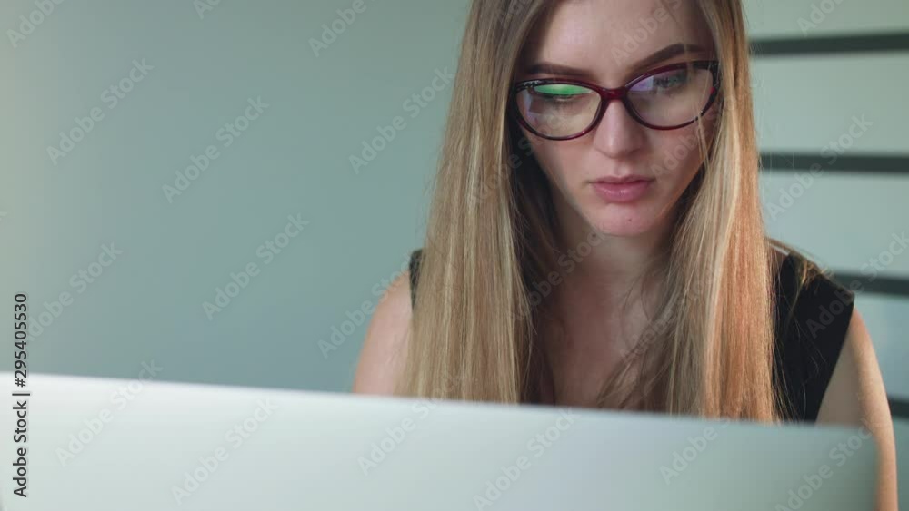 Portrait of serious woman working with laptop Portrait of serious woman working with laptop