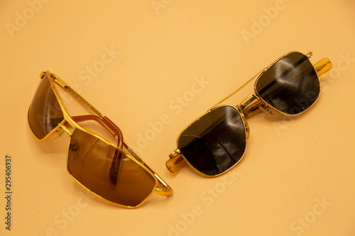 old vintage sunglasses gold frame and black glass . old-fashioned eye wearing classic collection with many copy space . accessory summer holiday concept
