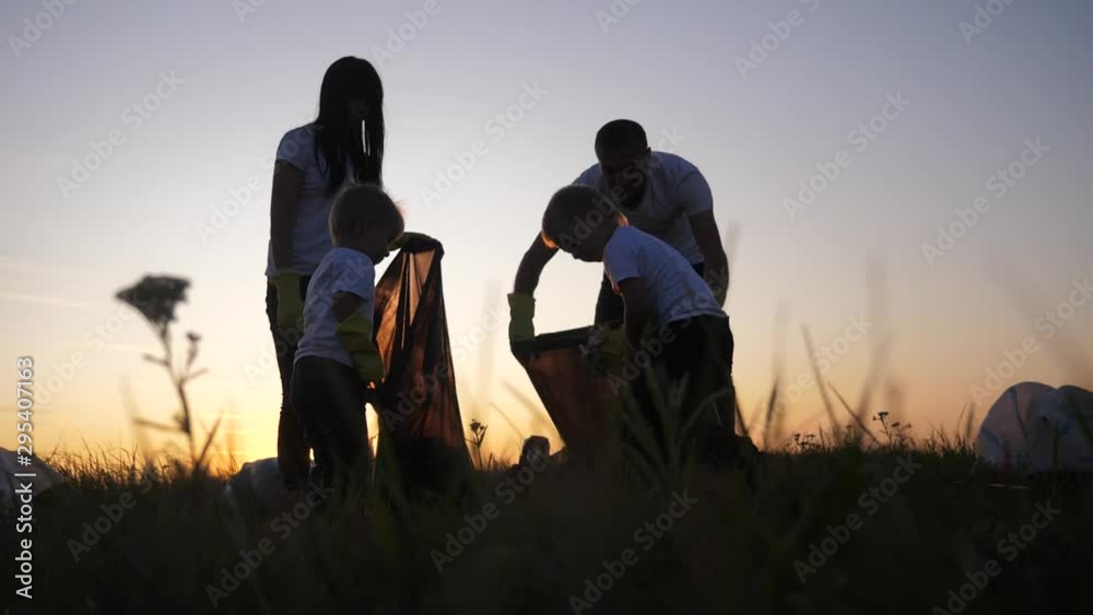 environmental teamwork a ecology teamwork volunteers awareness pollution household waste concept. people group happy family silhouette on the sunset lifestyle collects garbage plastic and paper waste environmental teamwork a ecology teamwork volunteers awareness pollution household waste concept. people group happy family silhouette on the sunset lifestyle collects garbage plastic and paper waste