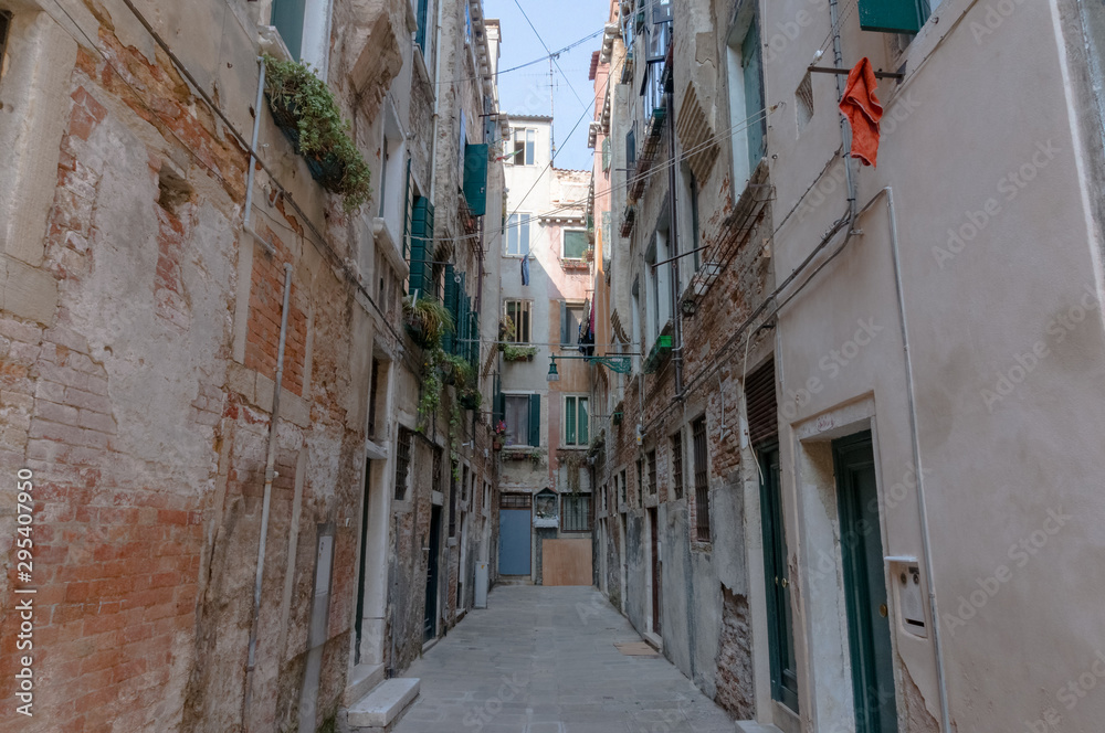Narrow Italian dead end street with old shabby buildings