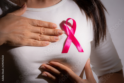 Wallpaper Mural Closeup of pink badge ribbon on woman chest to support breast cancer cause. Healthcare, medicine and breast cancer awareness concept. Torontodigital.ca
